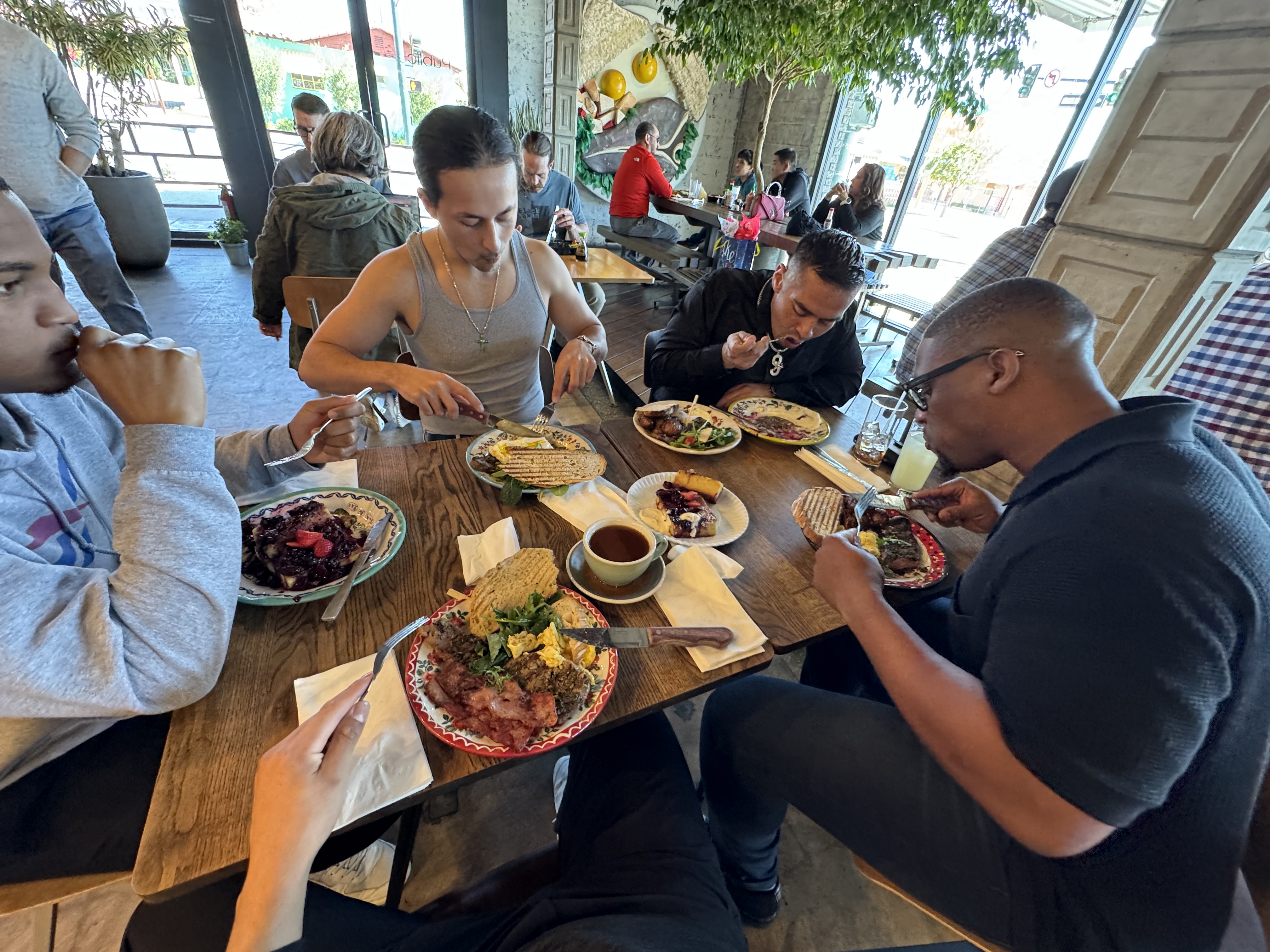 four guys eating brunch at a restaurant